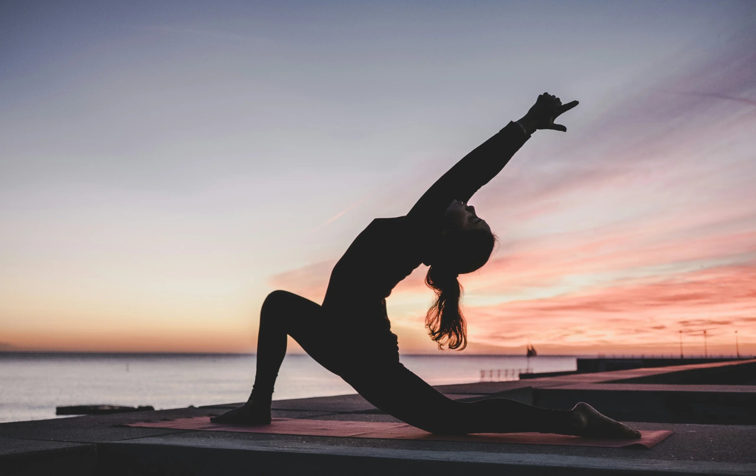 Silhouette photograph of woman doing yoga